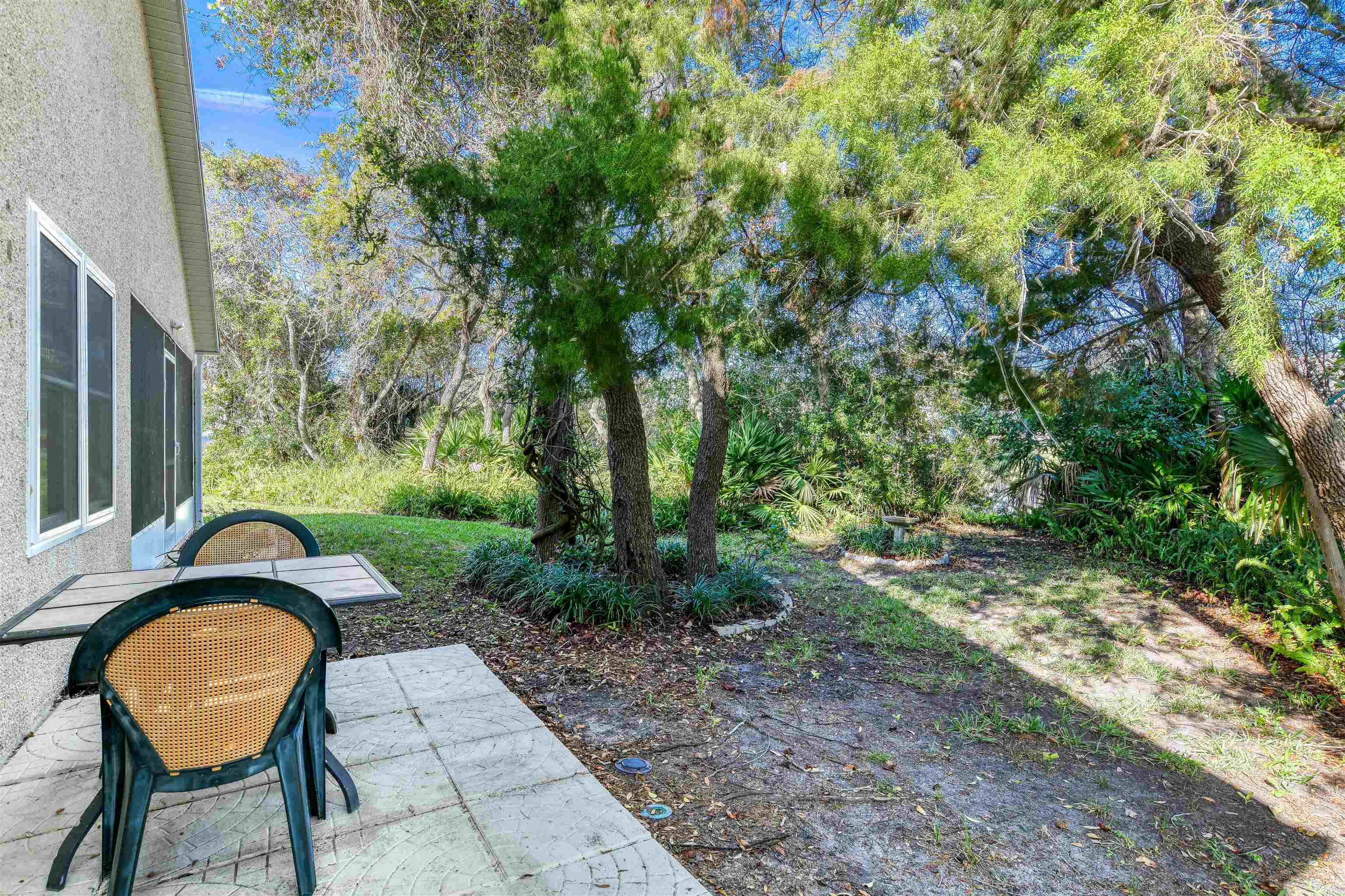541 Peninsula Court St. Augustine, FL 32080 - Photo 53 of 63 a backyard of a house with table and chairs