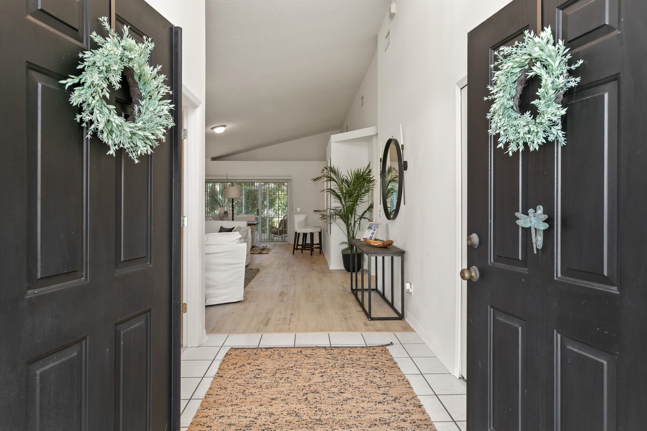 541 Peninsula Court St. Augustine, FL 32080 - Photo 8 of 63 a hallway with a vase of flowers sitting on a table