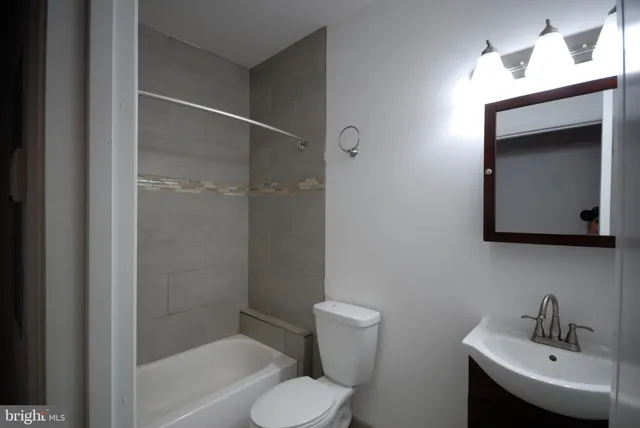 a bathroom with a toilet sink and shower
