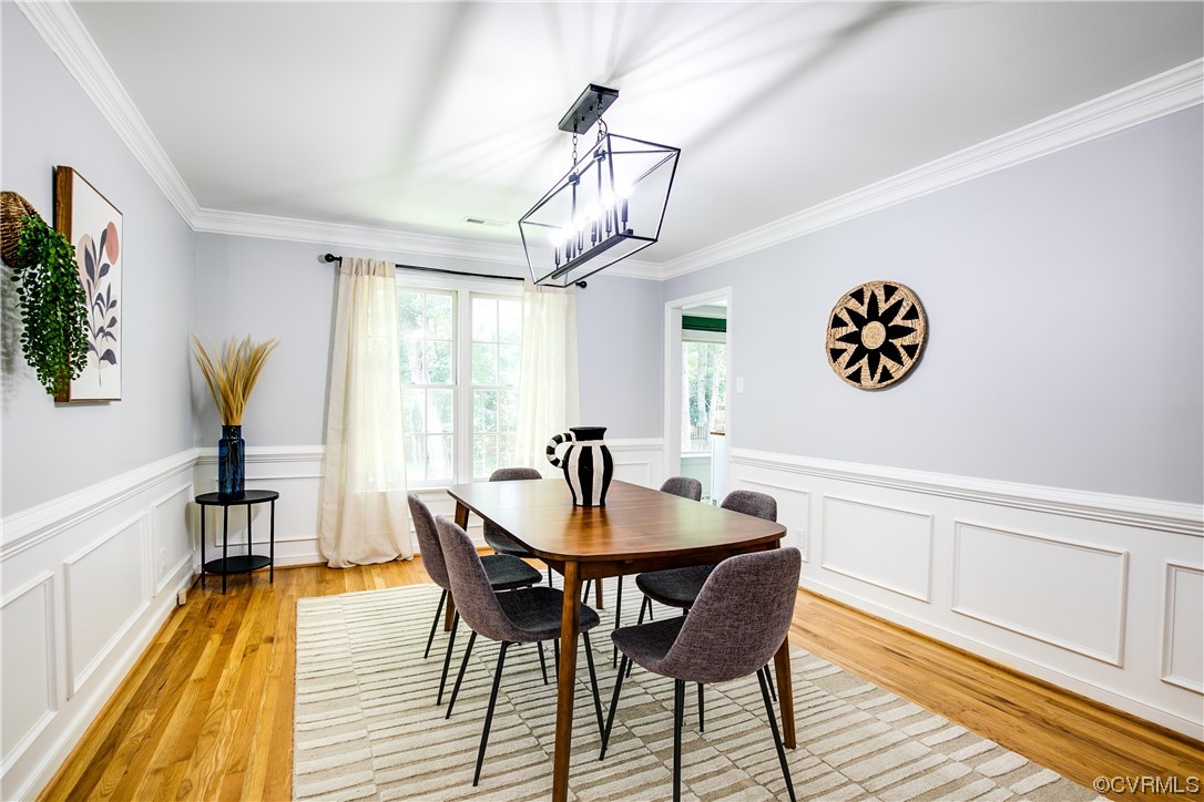 5709 Ridge Point Court Midlothian, VA 23112 - Photo 11 of 40 a dining room with furniture a chandelier and wooden floor