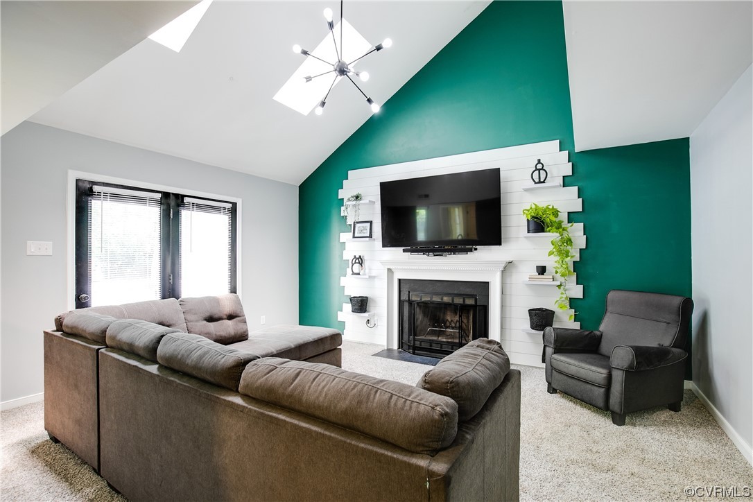 5709 Ridge Point Court Midlothian, VA 23112 - Photo 20 of 40 a living room with furniture a flat screen tv and a fireplace