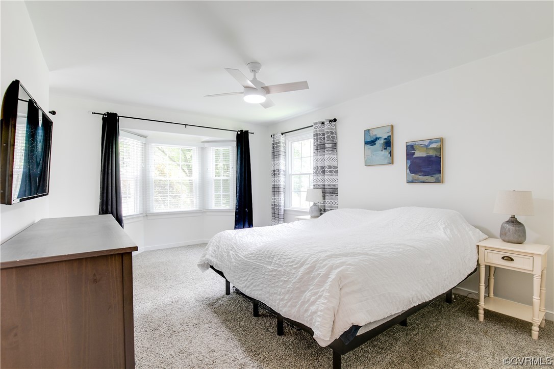 5709 Ridge Point Court Midlothian, VA 23112 - Photo 24 of 40 a bedroom with a large bed and a chandelier