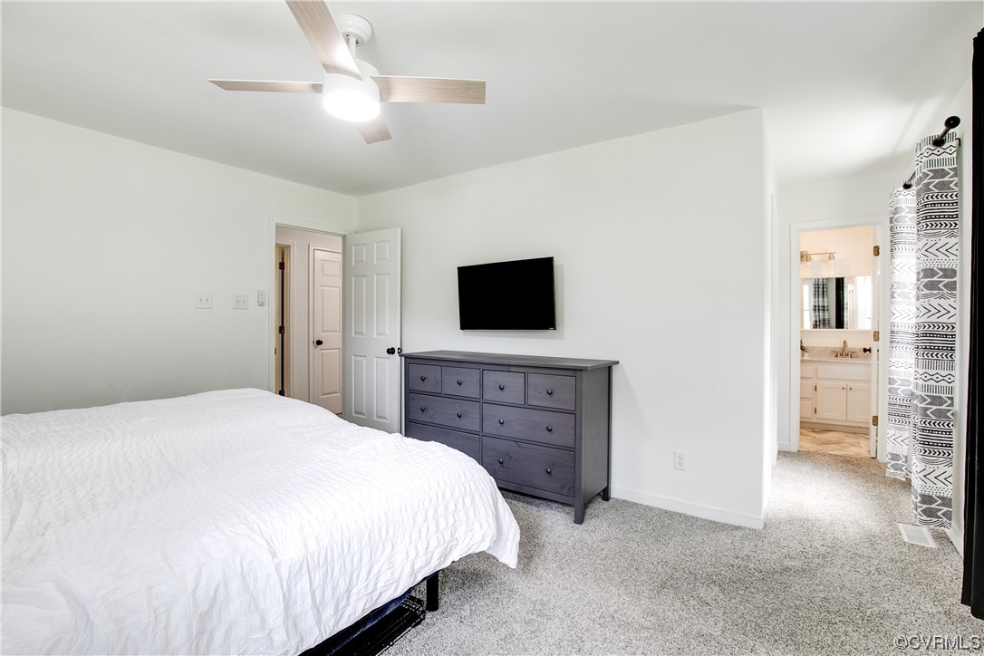 5709 Ridge Point Court Midlothian, VA 23112 - Photo 25 of 40 a spacious bedroom with a bed and a flat screen tv