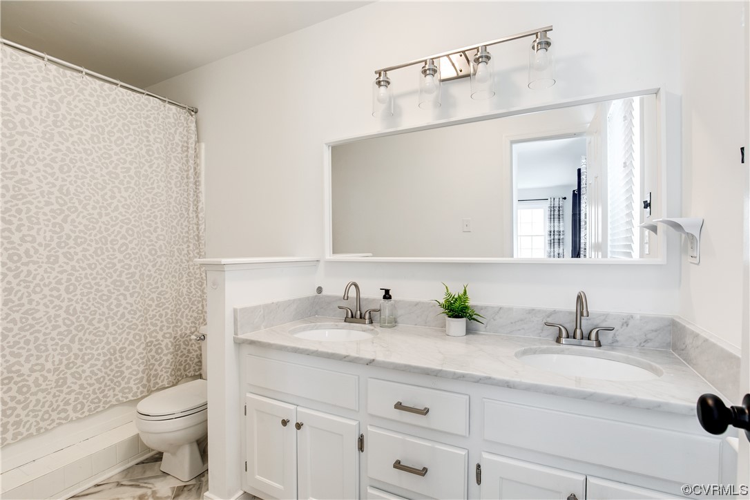 5709 Ridge Point Court Midlothian, VA 23112 - Photo 26 of 40 a bathroom with a granite countertop sink a toilet and a mirror