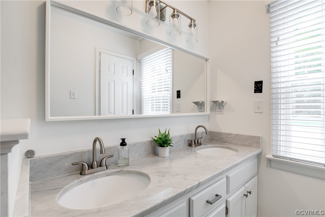 5709 Ridge Point Court Midlothian, VA 23112 - Photo 27 of 40 a bathroom with double sink and a mirror