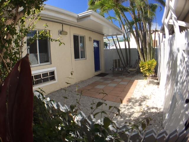 a view of backyard with barbeque grill and wooden fence