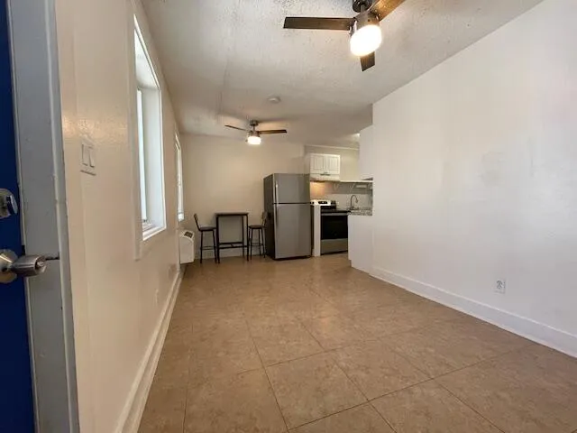 an empty room with fireplace and windows