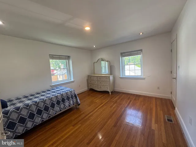 a spacious bedroom with a bed and a window