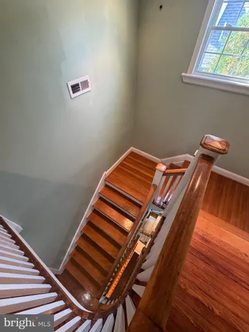 a view of a room with wooden floor