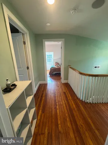 a view of a room with wooden floor