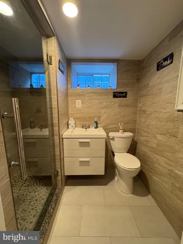 a bathroom with a toilet a sink and a mirror