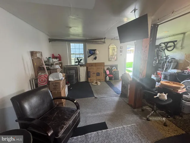 a living room with furniture a window and a flat screen tv