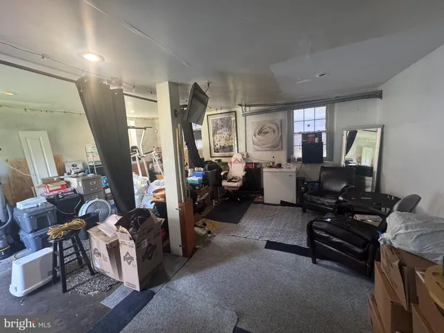 a living room with furniture and a piano