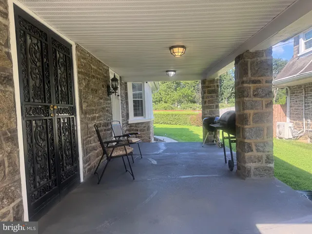 a view of a porch with furniture and a backyard