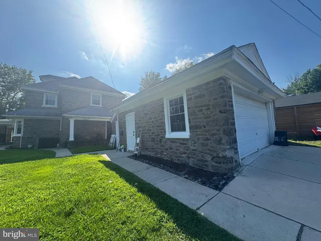 a view of a house with a yard and pathway