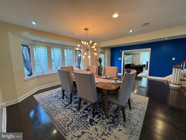 a view of a dining room with furniture and chandelier