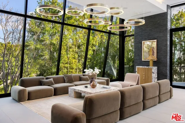 a living room with furniture and large windows