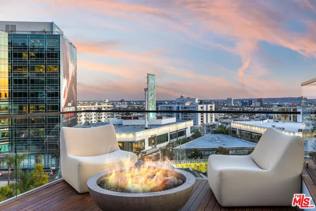 a view of a swimming pool with a couches and lounge chairs