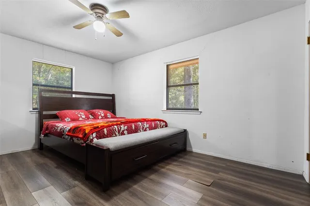 a bedroom with a bed and painting on the wall