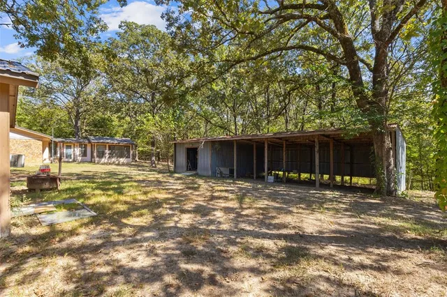 a backyard of a house with yard and tree s