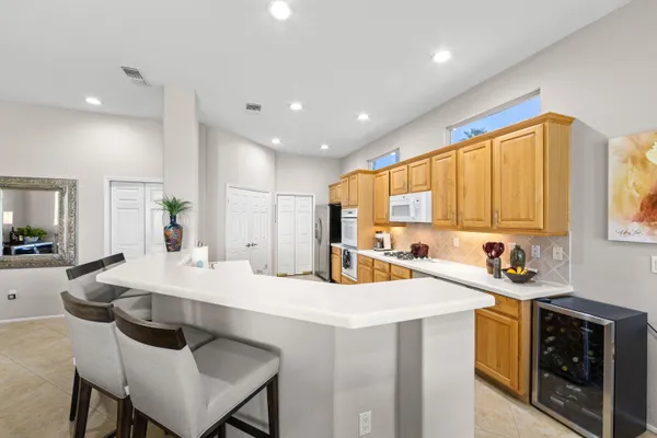 a kitchen with a sink a stove and chairs