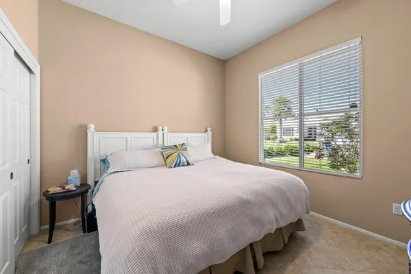a bedroom with a bed lamp and window