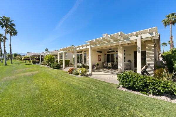 a view of a house with backyard porch and sitting area