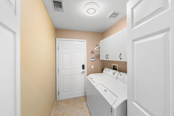 a view of a storage & utility room with dryer and washer