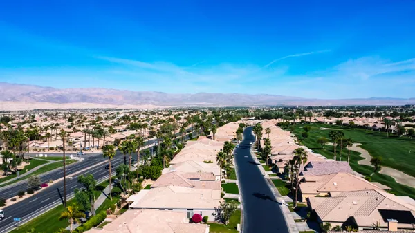 an aerial view of residential houses with outdoor space