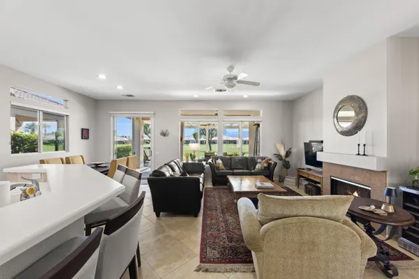 a living room with furniture a large window and a table