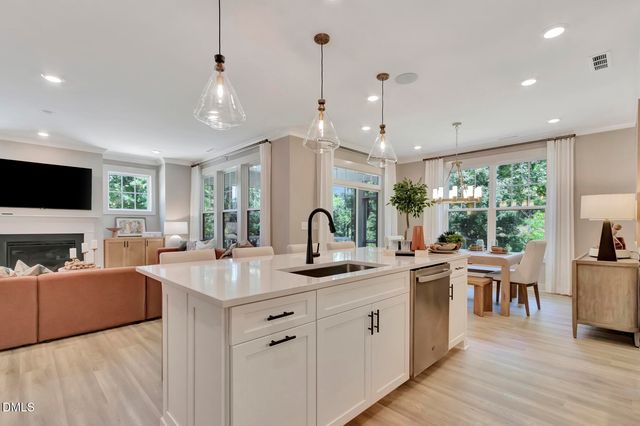 a kitchen with white cabinets and sink