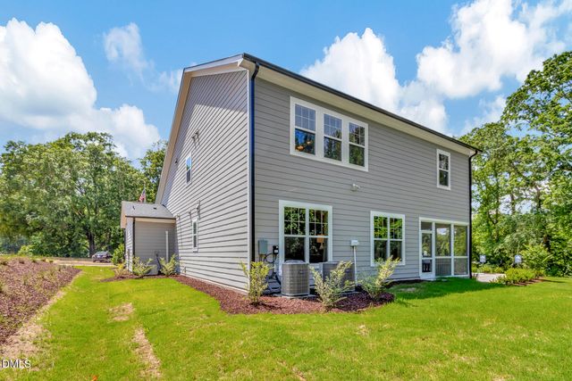 a front view of a house with a yard and porch