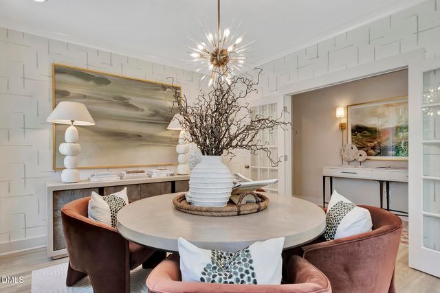 a view of a dining room with furniture and chandelier