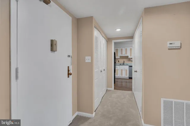 a view of a hallway with a bedroom and bathroom