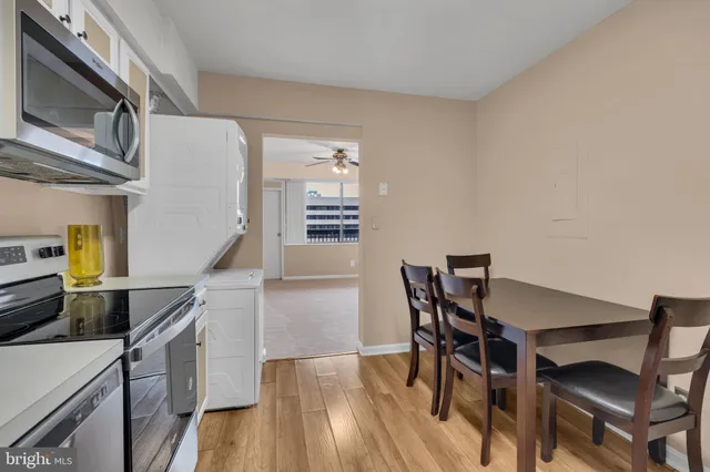 a kitchen with stainless steel appliances a microwave a stove and furniture