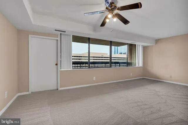 a living room with furniture and a ceiling fan