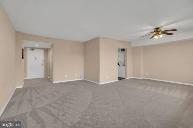 a view of a livingroom with an empty space and a window