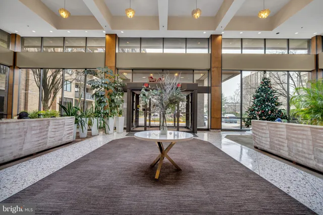 a lobby with a couch and a floor to ceiling window