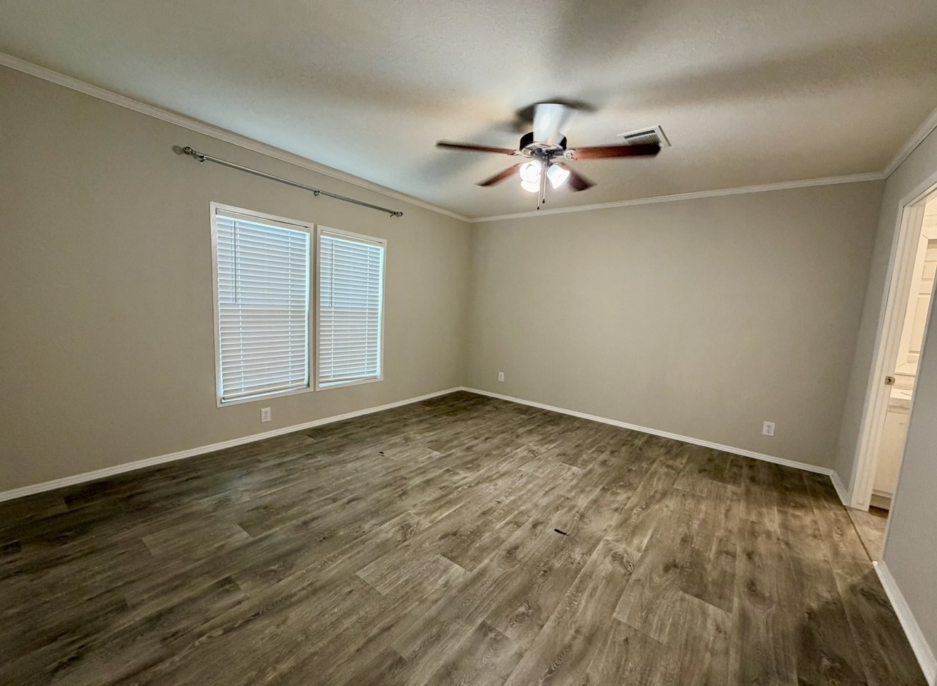 126 Castellana Way Elgin, TX 78621 - Photo 13 of 19 an empty room with wooden floor fan and windows