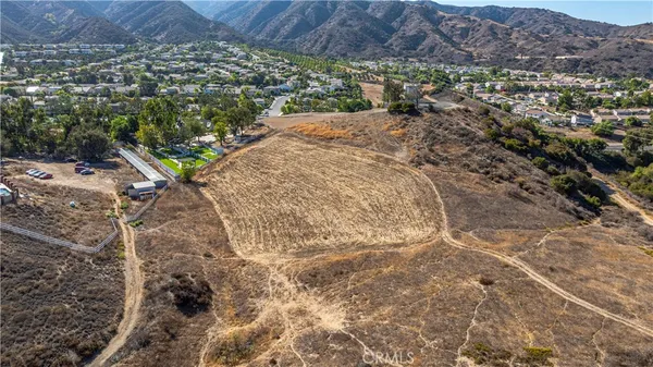 an aerial view of a house with a yard and lake view