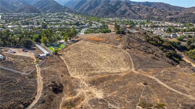 an aerial view of a house with a yard and lake view