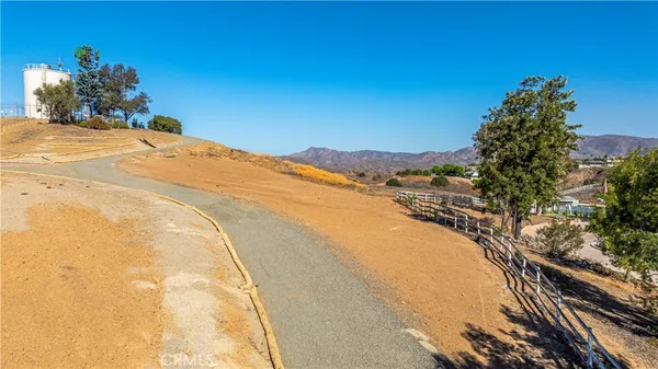 a view of a dry yard with mountains in the background