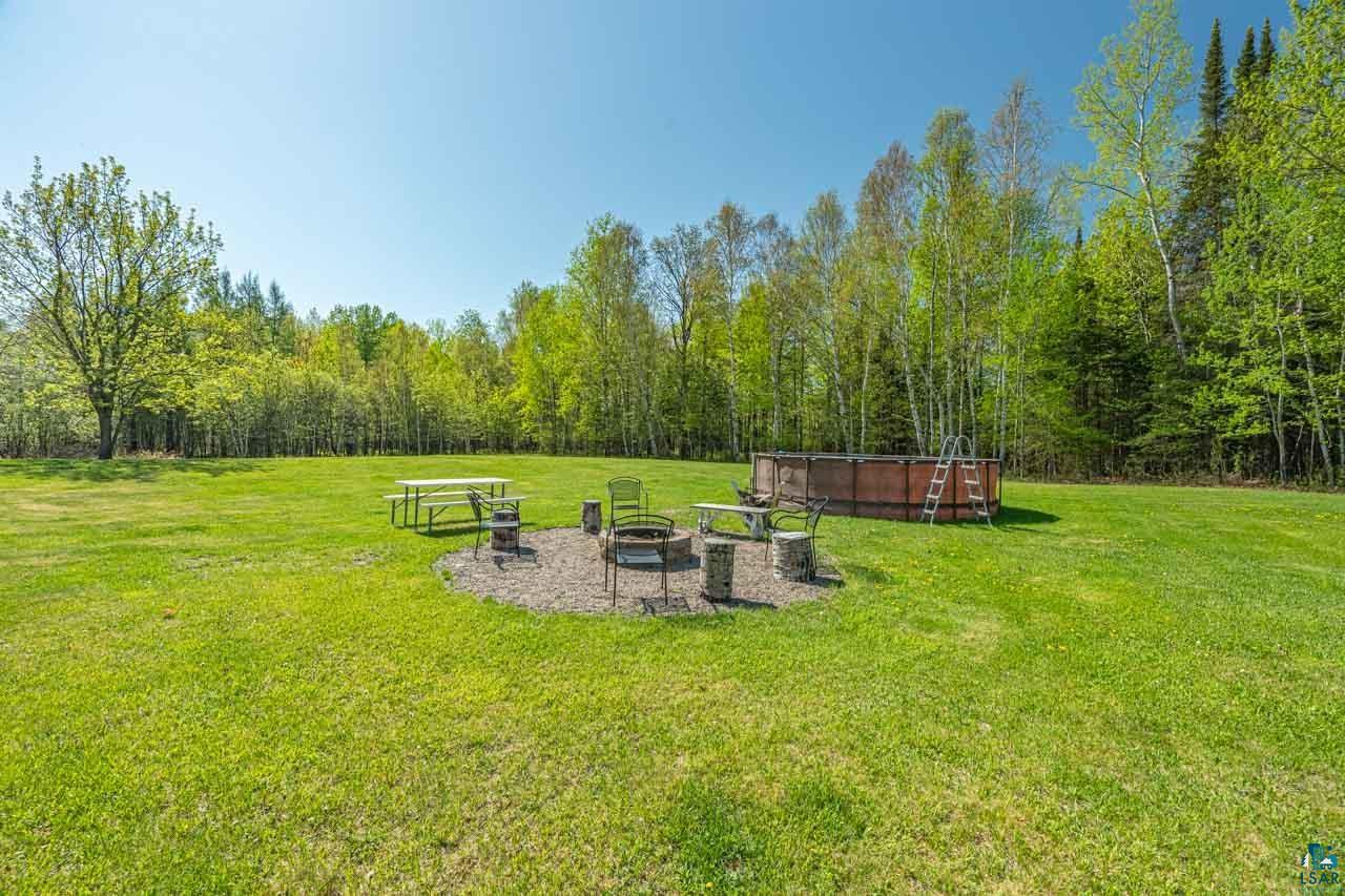 2581 O'Rourke Road Hibbing, MN 55746 - Photo 35 of 61 Expansive green lawn with a dedicated fire pit area