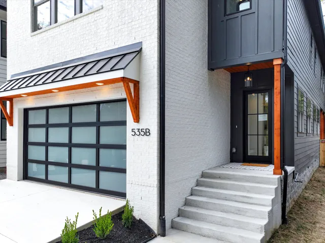a living room with furniture fireplace and a window