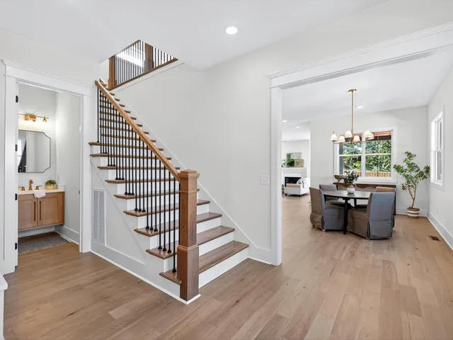 a bathroom with a double vanity sink a large mirror and a glass door shower