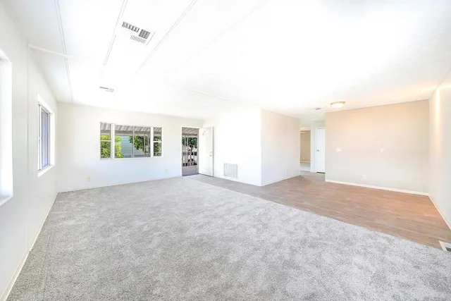 a view of a room with a windows and ceiling fan