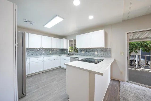 a kitchen with a white stove top oven sink and cabinets
