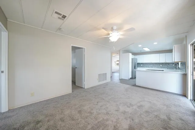 a view of a kitchen with a sink and a refrigerator