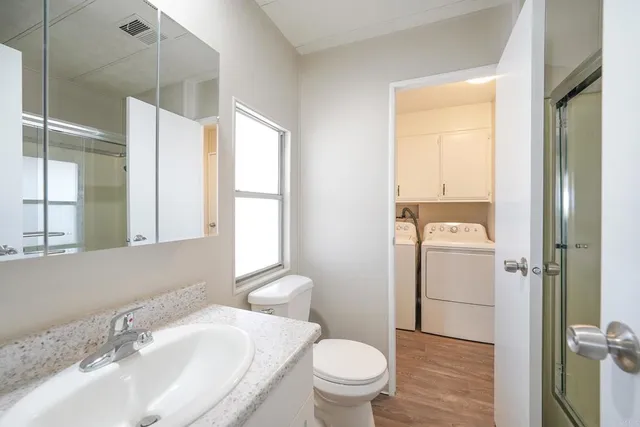 a bathroom with a sink toilet and shower