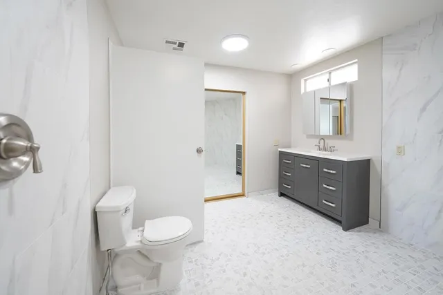 a bathroom with a toilet and a shower